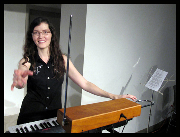 A crowd watches as Jess Hyperbubble plays the theremin